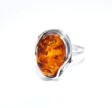 Ring with amber 18x13.5 mm with 2 small silver leaves (925)